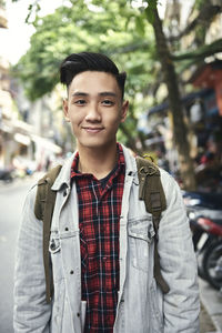 Portrait of young man standing outdoors