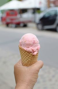 Close-up of hand holding ice cream cone