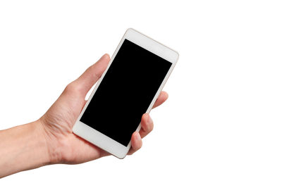 Low angle view of hand holding smart phone against white background