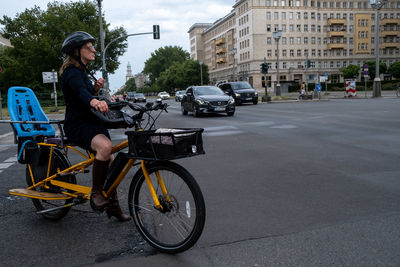 Man riding bicycle on street in city