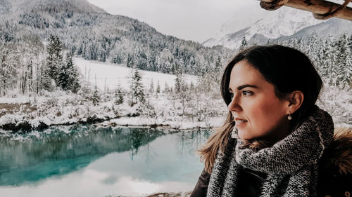 Portrait of young woman at beautiful lake in winter. mountains, snow. zelenci, slovenia.