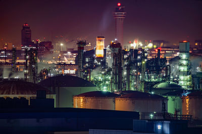 Illuminated cityscape against sky at night