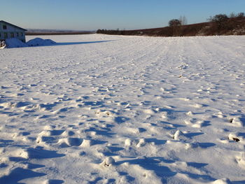 Scenic view of snow covered landscape against sky