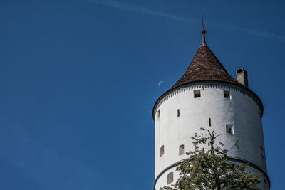 Low angle view of bell tower against blue sky