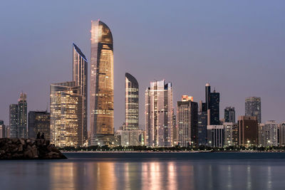 Illuminated city at waterfront