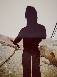 Shadow of man and woman standing on sand