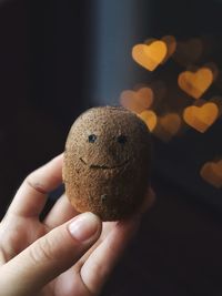 Cropped hand holding kiwi fruit