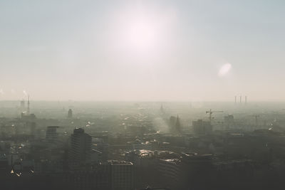 Cityscape by sea against sky