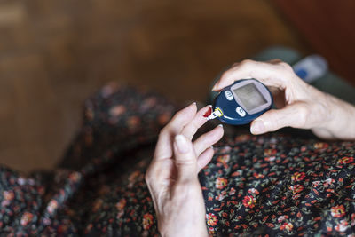 Midsection of person using mobile phone