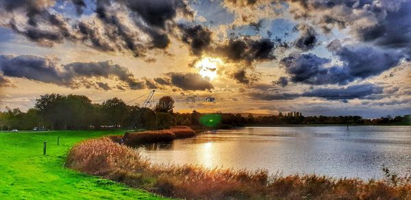 Scenic view of lake against sky during sunset