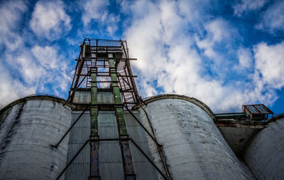 Low angle view of crane against sky