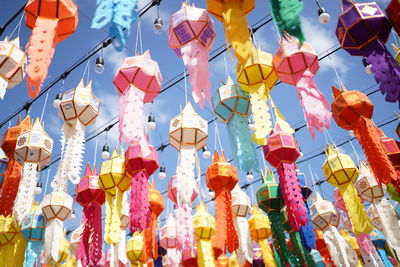 Low angle view of lanterns hanging against sky