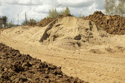 Construction sand. mountain of sand on construction site. excavated earth. 