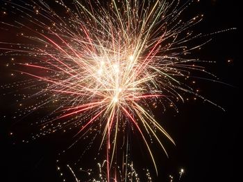 Low angle view of firework display at night