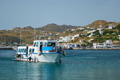 Boat in port harbor of chora town on mykonos island, greece