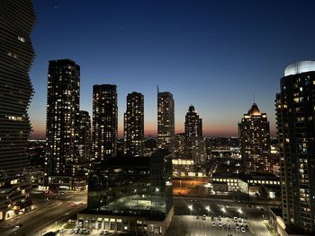 Illuminated buildings in city at night