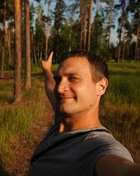 Portrait of young man standing on field