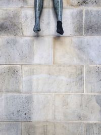 Cropped image of sculpture with sock against wall