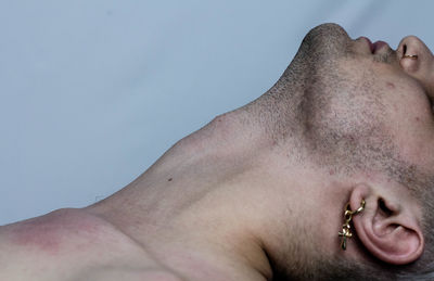 Close-up portrait of shirtless man