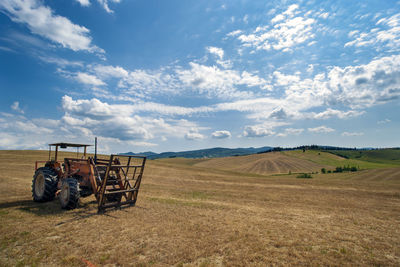 A harvester in a wheat field in the tuscan countryside