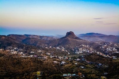 High angle view of townscape and mountains against sky