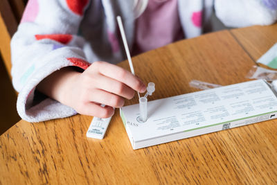 Child testing herself for coronavirus at home.