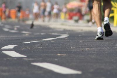 Low section of man running on road