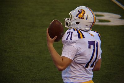 Rear view of man playing with ball