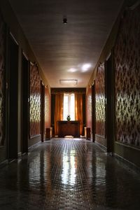 Empty corridor in illuminated building