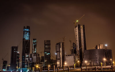 Low angle view of skyscrapers lit up at night