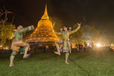 Group of people at illuminated temple