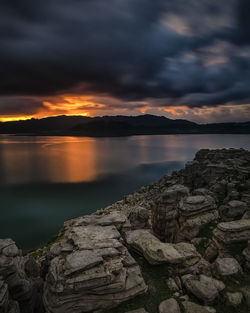 Scenic view of lake against sky during sunset