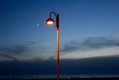 Low angle view of street light against sky at dusk