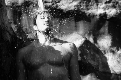 Water splashing on shirtless man