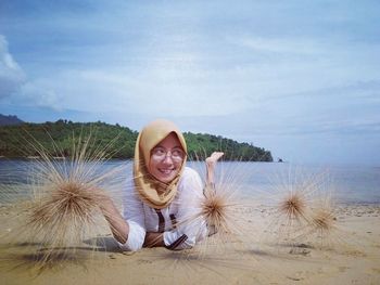Portrait of smiling young woman on beach