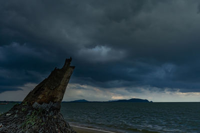 Scenic view of sea against storm clouds