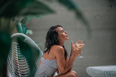 Midsection of a woman drinking water