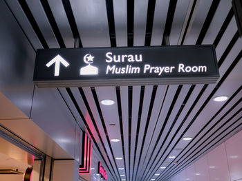 Low angle view of sign on escalator