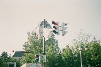 Low angle view of road signal against buildings