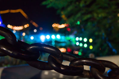 Close-up of illuminated chain at night