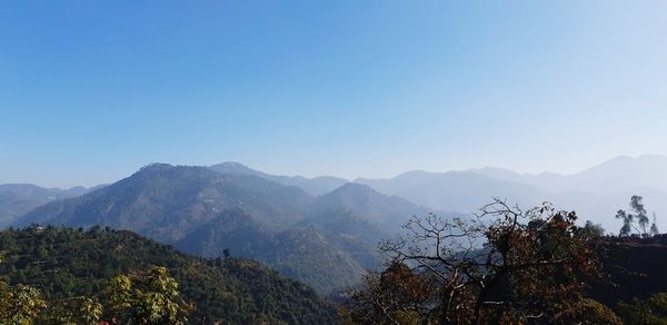 Scenic view of mountains against clear blue sky