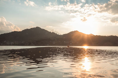 Scenic view of lake against sky during sunset