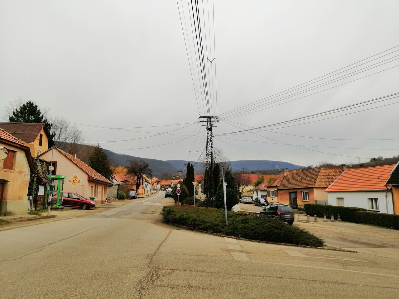 STREET AMIDST BUILDINGS AGAINST SKY