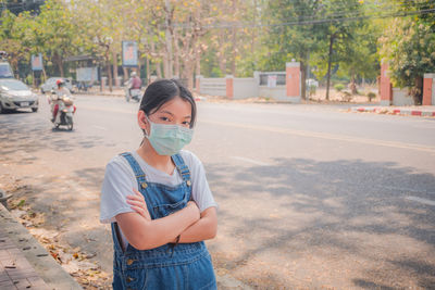 Coronavirus and air pollution pm2.5 concept. young girl wearing face mask protective for spreading.