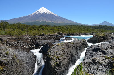 Scenic view of mountains against clear blue sky