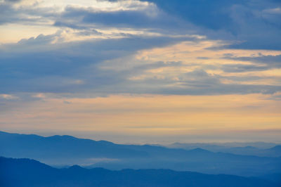 Scenic view of mountains against cloudy sky