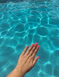 Low section of woman swimming in pool