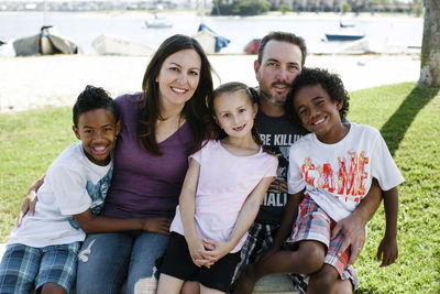 Portrait of happy family sitting on field