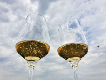 Low angle view of wine glass against sky