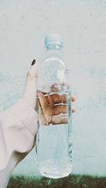 Close-up of hand holding water bottle